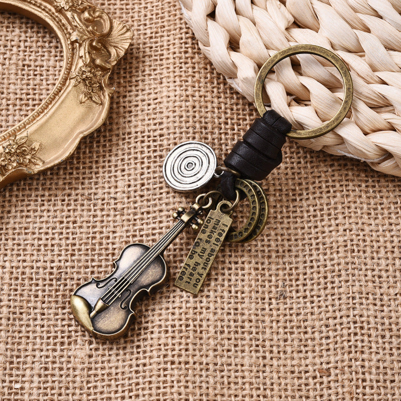 Llavero de guitarra vintage con personalidad sencilla, tejido de piel de vaca, para amantes de la música.