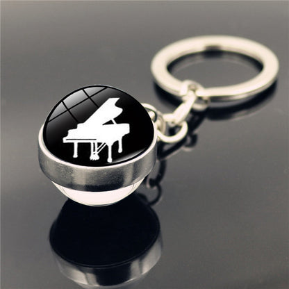 Llavero con colgante de piedra del tiempo y instrumento musical de piano